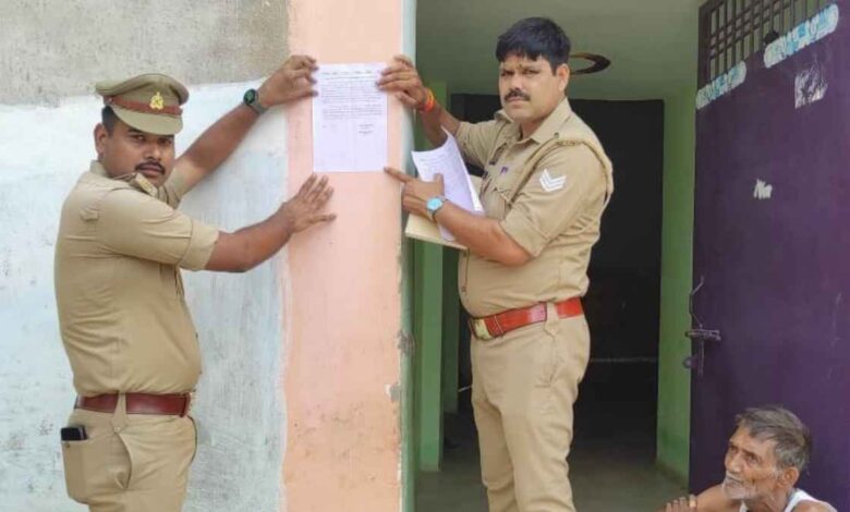 रसूलाबाद के ग्राम सेंगरन निवादा में फरार आरोपी के घर नोटिस चस्पा करती पुलिस।
